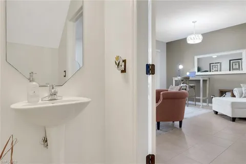 a living room with furniture and a mirror