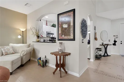 a living room with furniture and a mirror