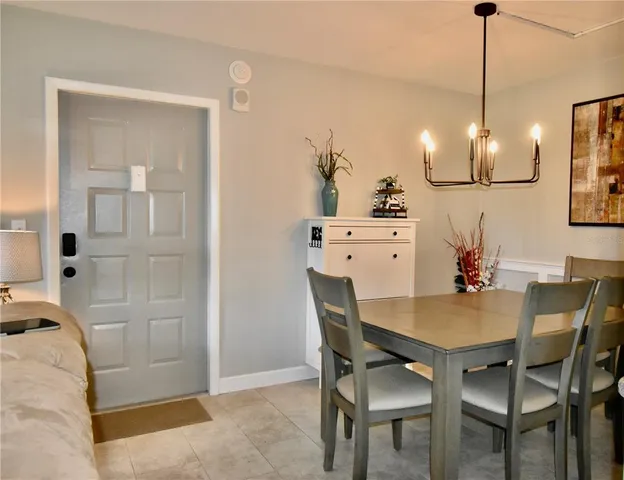 a view of a dining room with furniture and chandelier