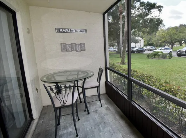 a living room with couch and a floor to ceiling window