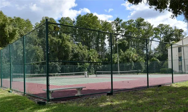 a front view of a house with a garden and trees