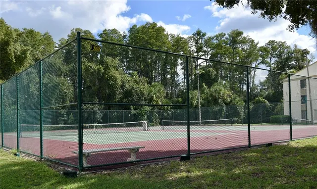 a front view of a house with a garden and trees