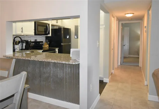 a view of a kitchen from the hallway