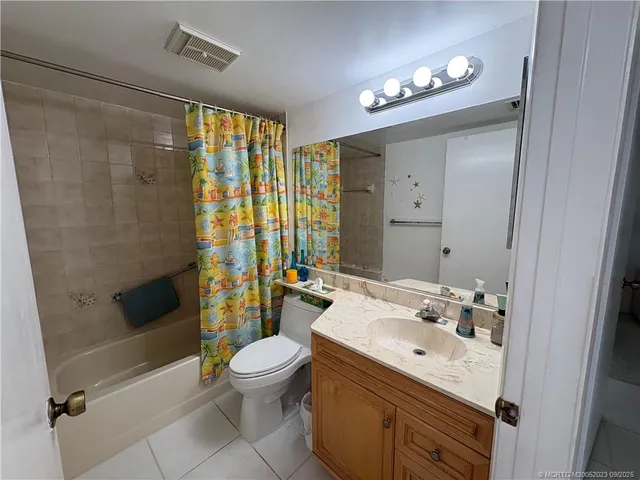 a bathroom with a sink a toilet a mirror and shower