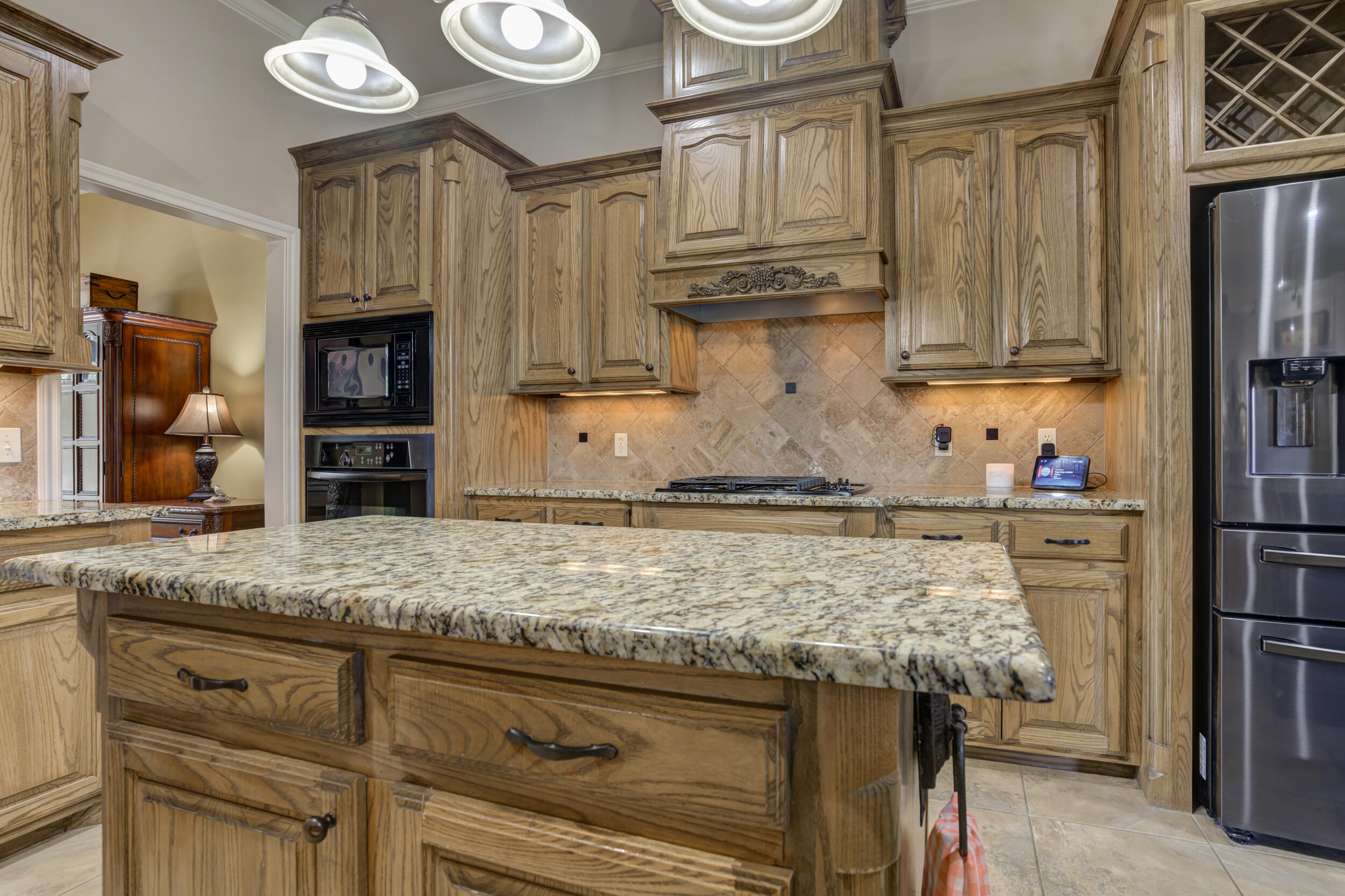 6008 89th Street Lubbock, TX 79424 - Photo 19 of 61 a kitchen with stainless steel appliances granite countertop a sink stove and refrigerator