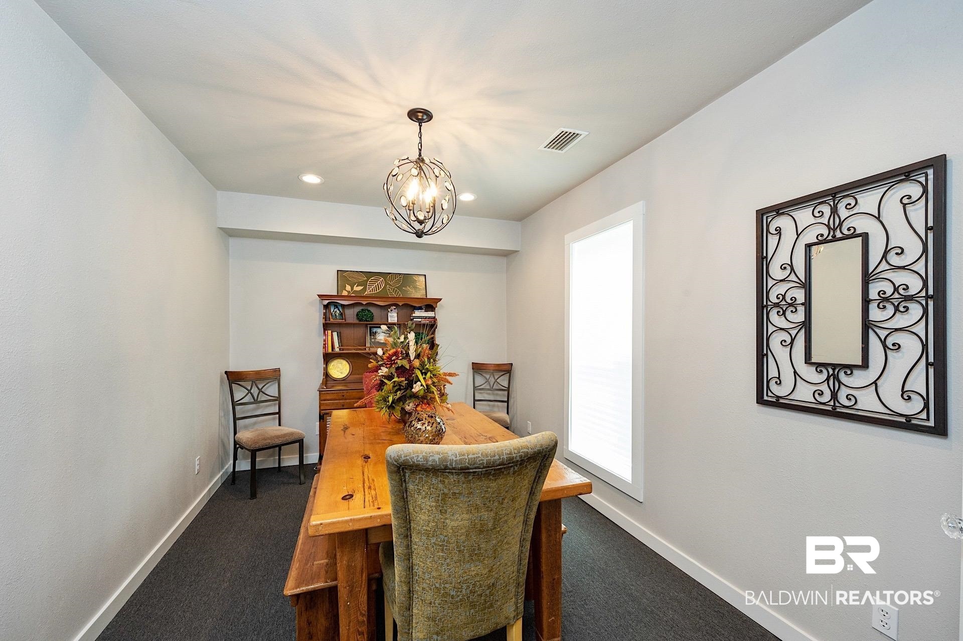 22051 Broad Street Silverhill, AL 36576 - Photo 9 of 28 Carpeted dining area with a chandelier