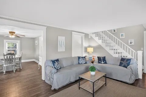 a living room with furniture and wooden floor