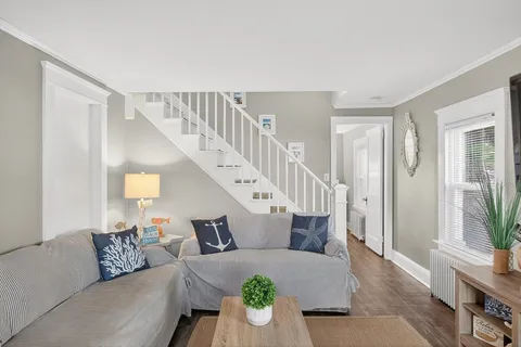 a living room with furniture and wooden floor