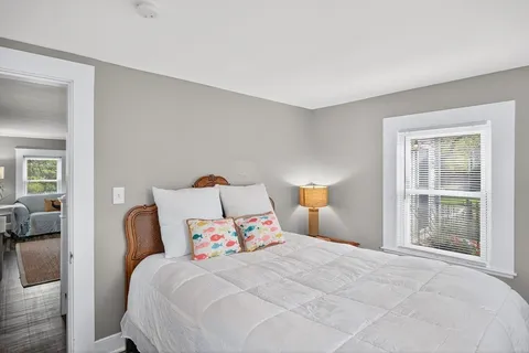 a bedroom with a bed and a large window