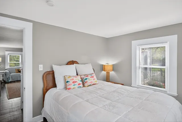 a bedroom with a bed and a large window