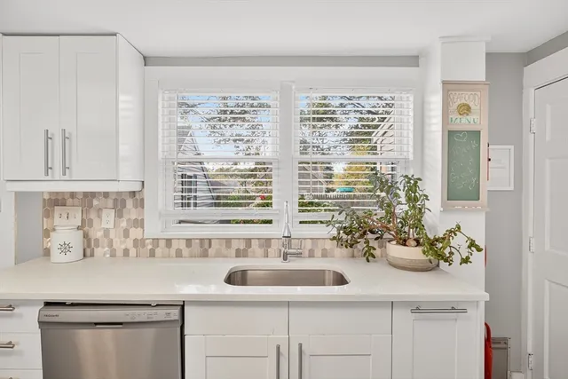 a bathroom with a sink and a window