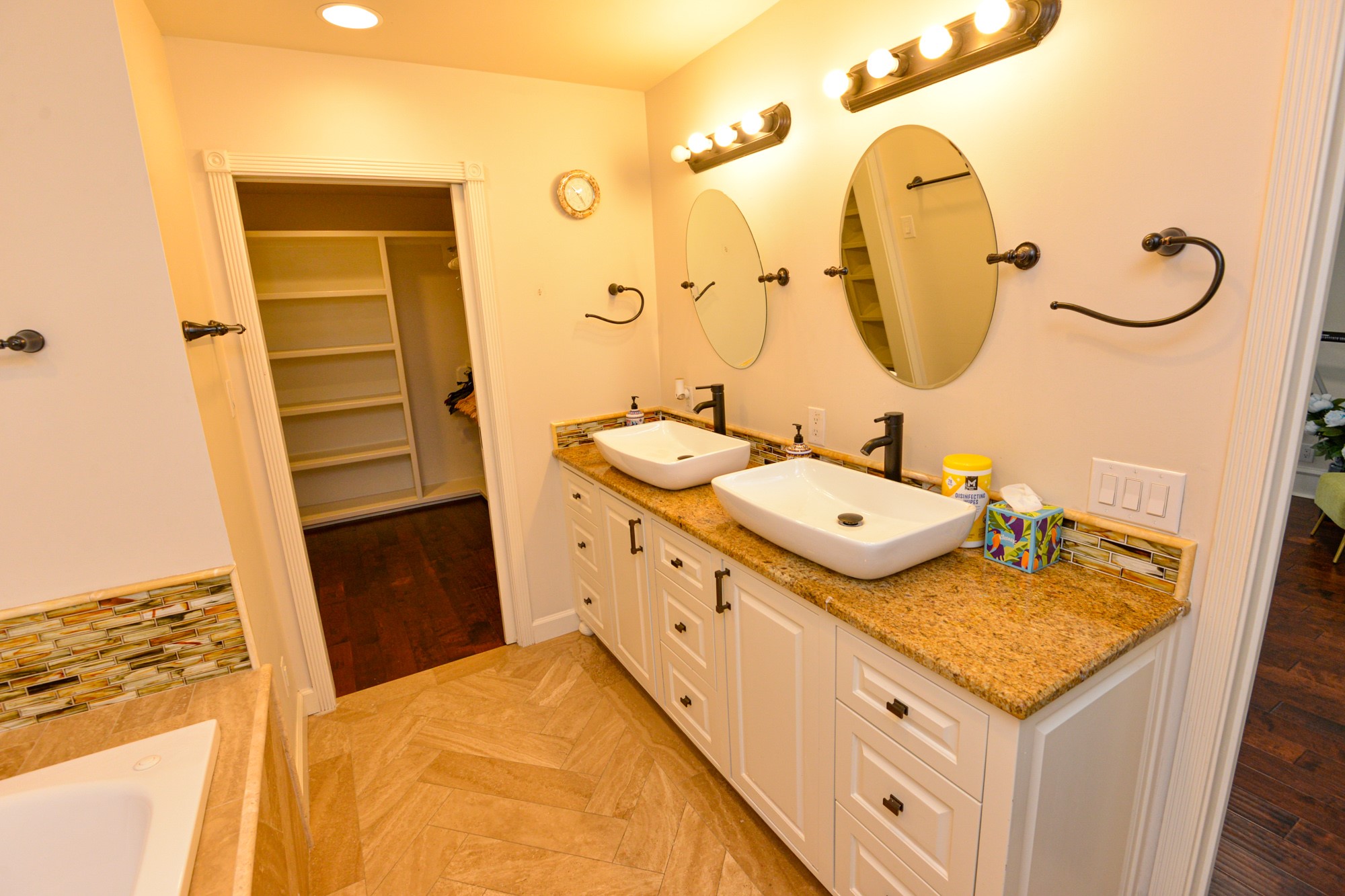 10710 D-K Ranch Road Austin, TX 78759 - Photo 19 of 34 Granite counters and dual vessel sinks define this well-appointed bathroom with a walk-in closet.