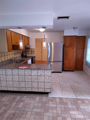 a spacious bathroom with a granite countertop sink a mirror and a shower