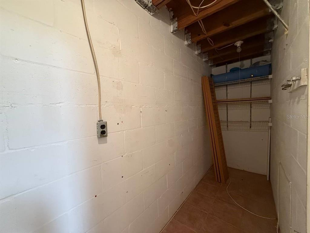 1217 McMullen Booth Road Clearwater, FL 33759 - Photo 11 of 44 a view of storage and utility room with racks on the wall