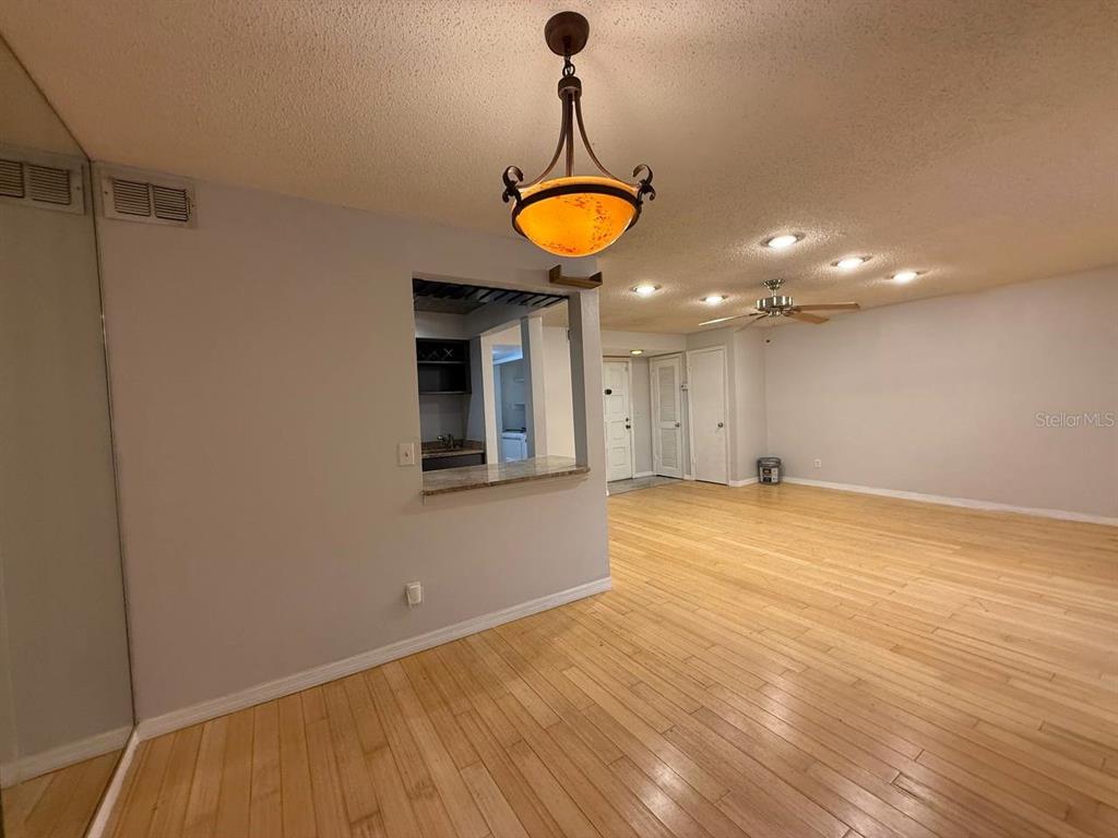 1217 McMullen Booth Road Clearwater, FL 33759 - Photo 15 of 44 a view of a room with wooden floor and a ceiling fan