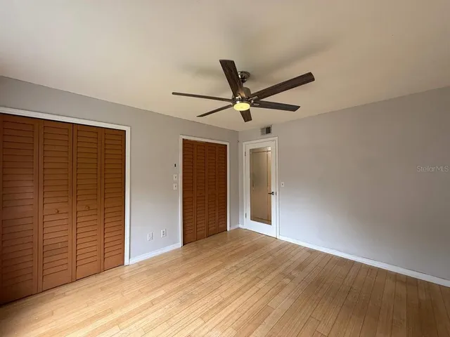an empty room with closet and a window