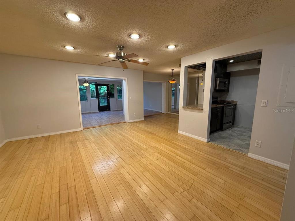 1217 McMullen Booth Road Clearwater, FL 33759 - Photo 4 of 44 a view of an empty room with wooden floor