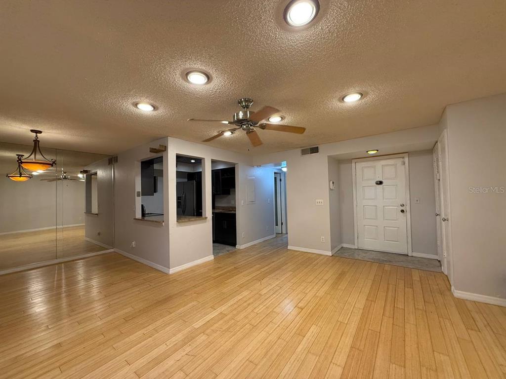 1217 McMullen Booth Road Clearwater, FL 33759 - Photo 8 of 44 a view of an empty room with kitchen and a window