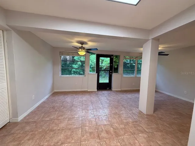 an empty room with windows and entrance