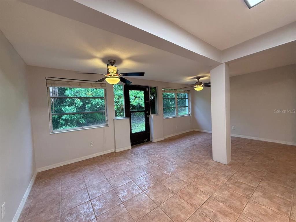 1217 McMullen Booth Road Clearwater, FL 33759 - Photo 10 of 44 an empty room with windows and entrance