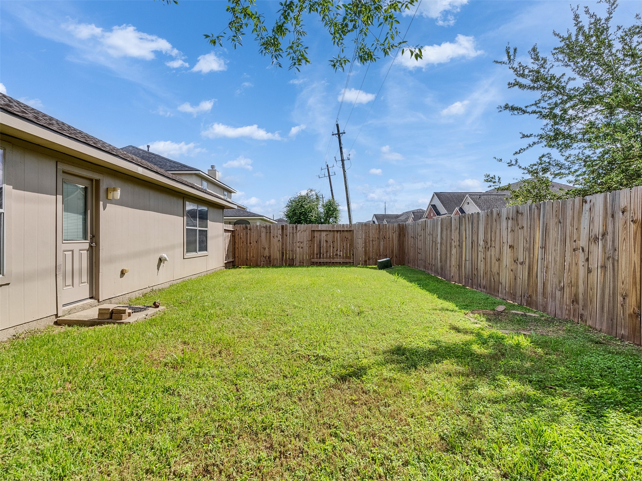 13431 Rural Oak Street Houston, TX 77034 - Photo 22 of 24 a view of a backyard with potted plants and wooden fence