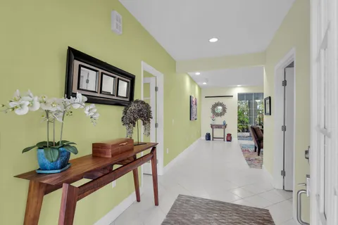 a kitchen with kitchen island granite countertop a sink and white cabinets