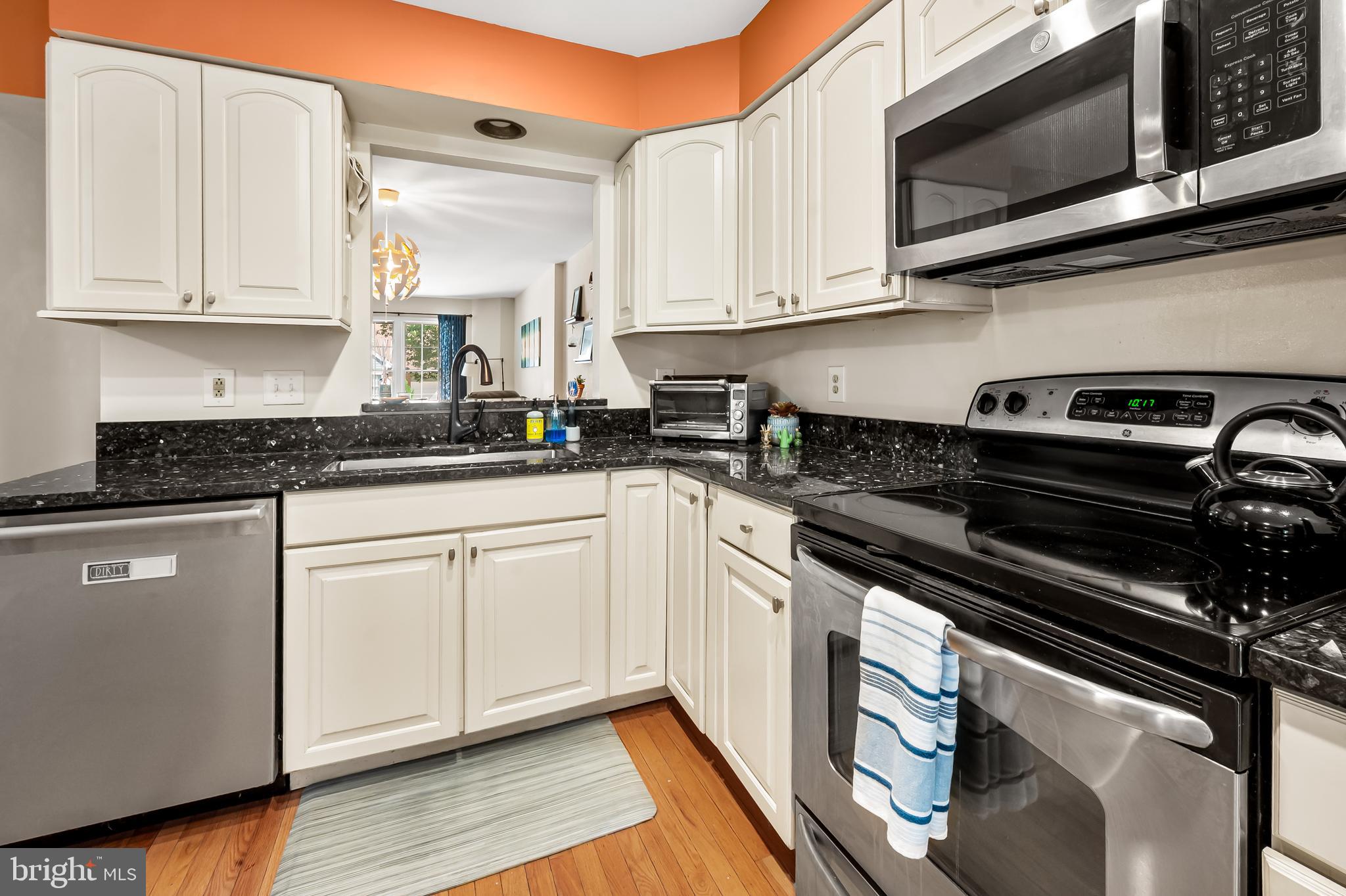167 Spring Pl Way Annapolis, MD 21401 - Photo 11 of 38 a kitchen with stainless steel appliances granite countertop white cabinets granite counter tops and a wooden floors