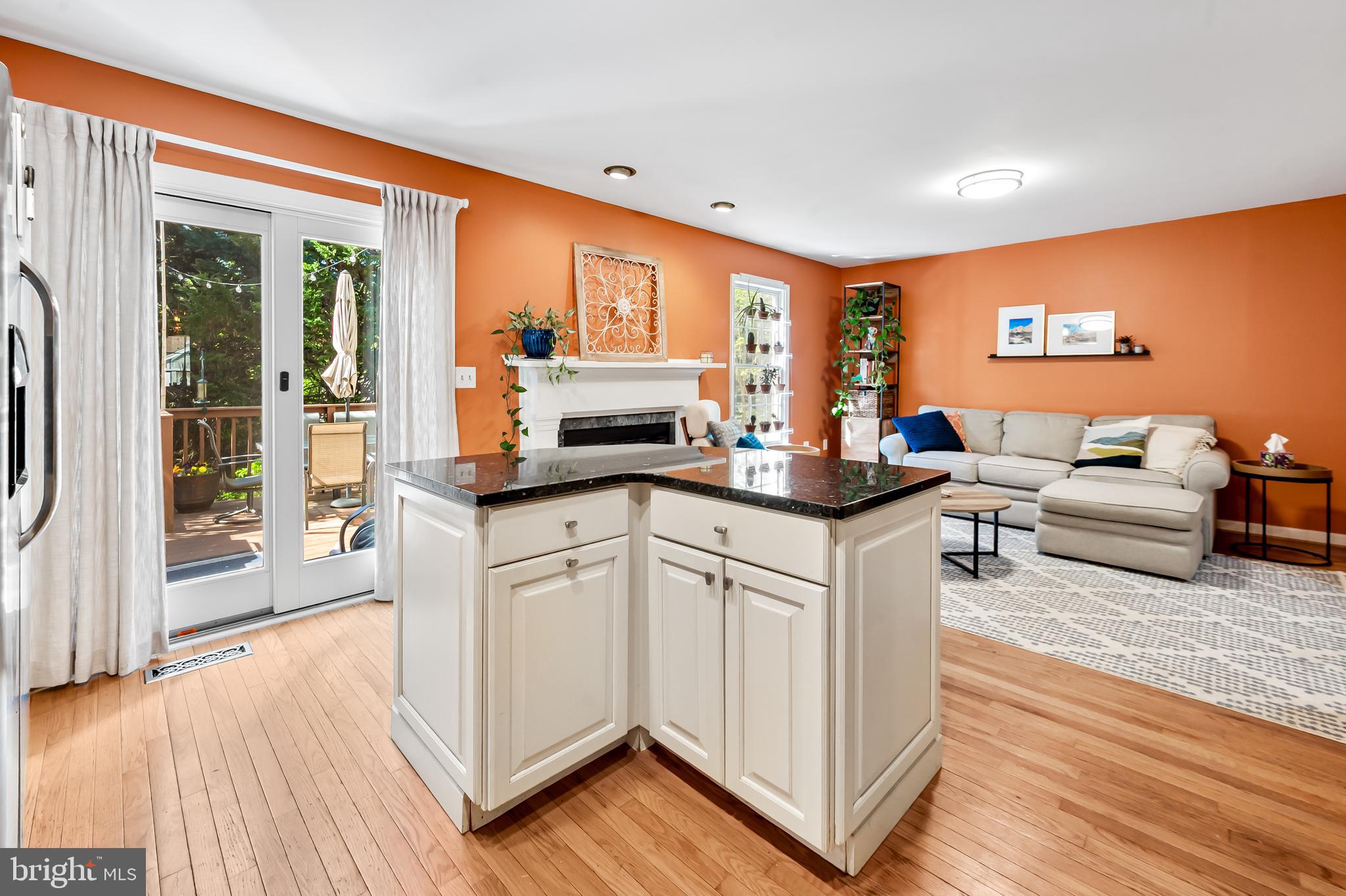 167 Spring Pl Way Annapolis, MD 21401 - Photo 14 of 38 a kitchen with stainless steel appliances granite countertop a stove a sink dishwasher and a dining table with wooden floor