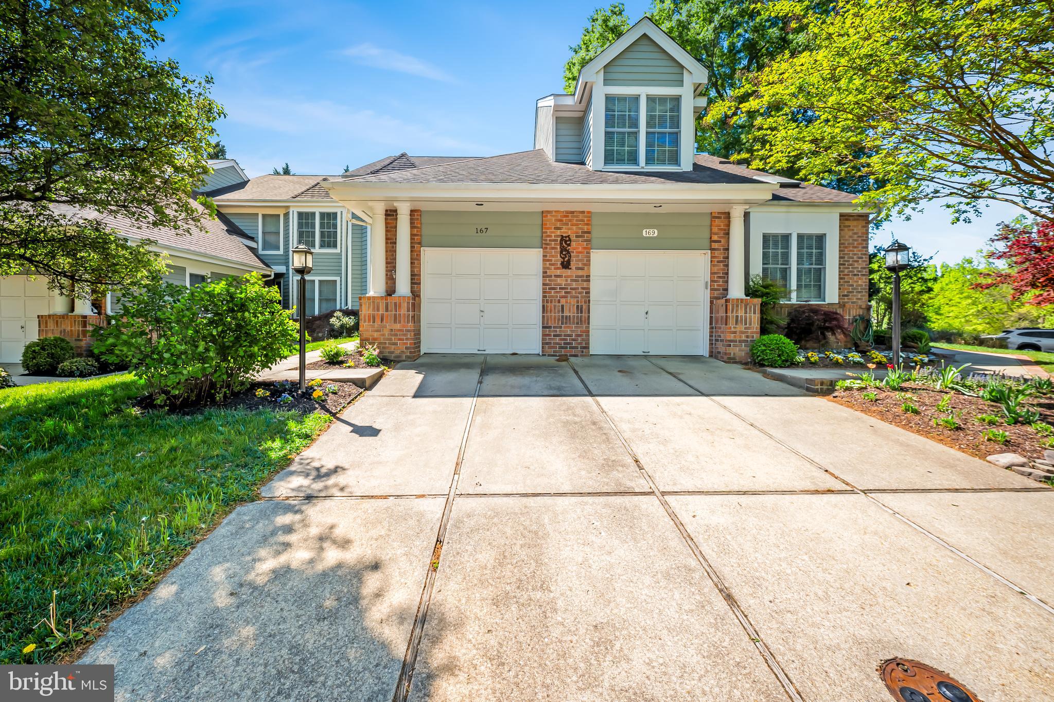 167 Spring Pl Way Annapolis, MD 21401 - Photo 2 of 38 a front view of a house with a yard and a garage