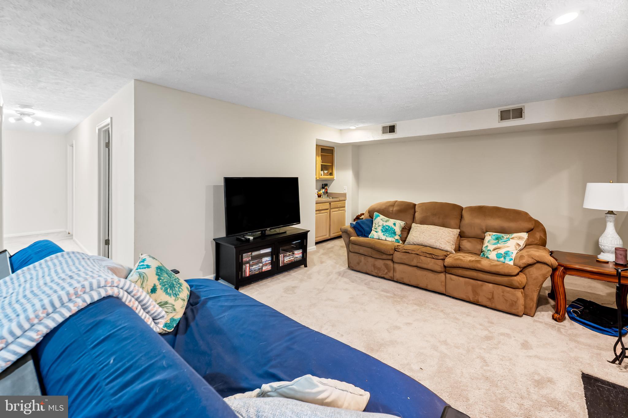 167 Spring Pl Way Annapolis, MD 21401 - Photo 32 of 38 a living room with furniture and a flat screen tv