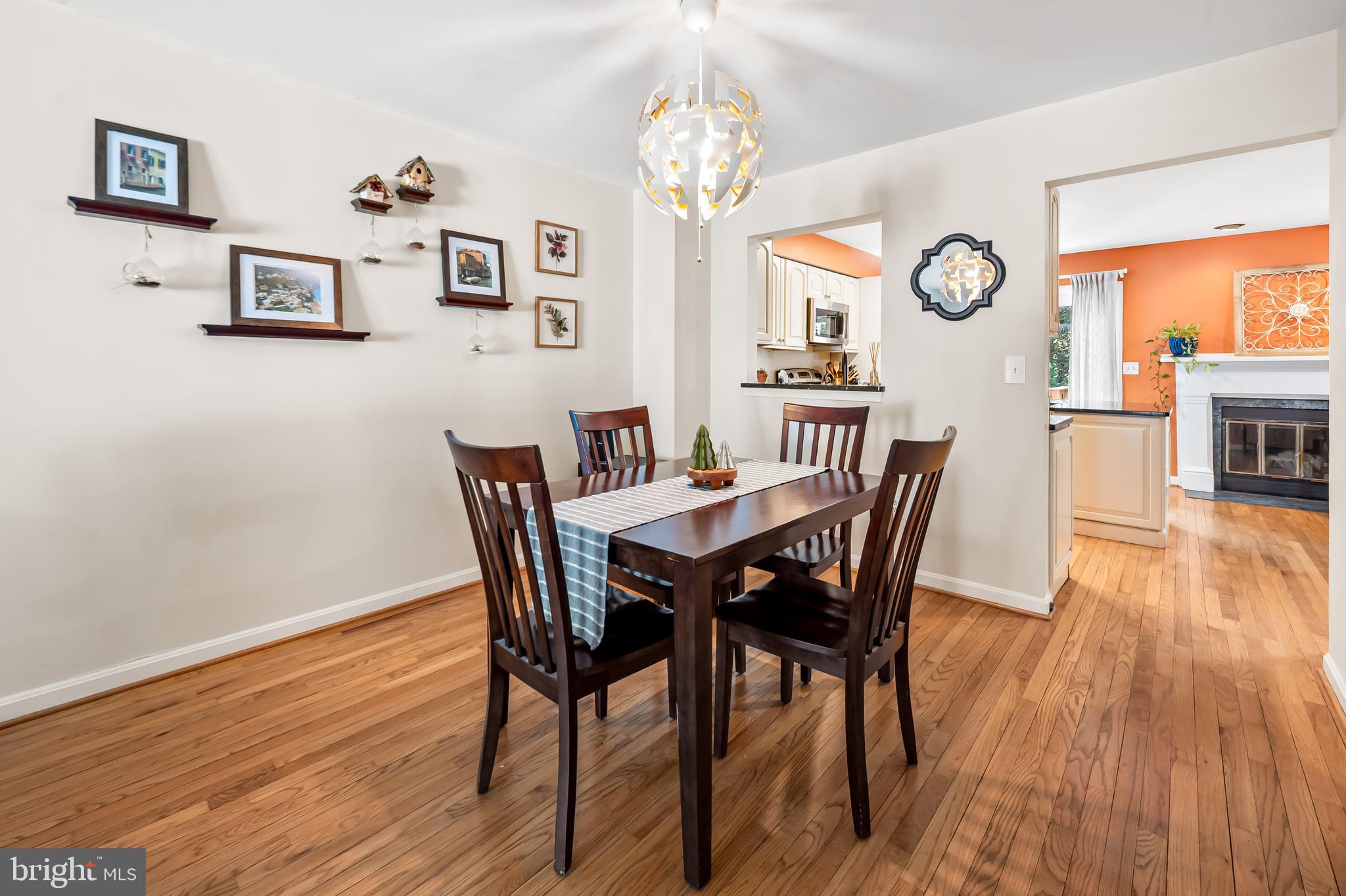 167 Spring Pl Way Annapolis, MD 21401 - Photo 9 of 38 a view of a dining room with furniture a chandelier and wooden floor