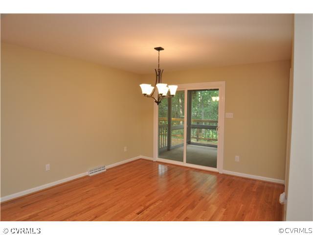 13804 Winterberry Ridge Midlothian, VA 23112 - Photo 5 of 12 a view of a room with wooden floor and chandelier