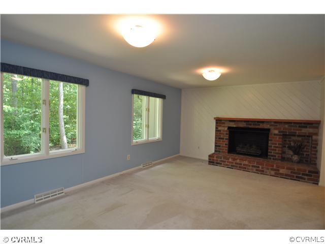 13804 Winterberry Ridge Midlothian, VA 23112 - Photo 6 of 12 a view of an empty room with a fireplace and a window