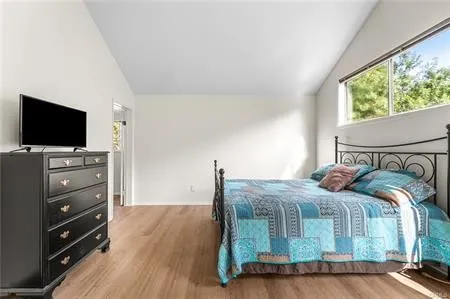 a bedroom with a bed and a television