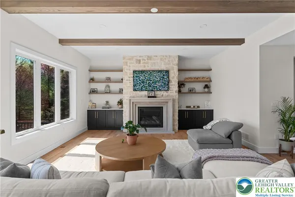 a kitchen with stainless steel appliances granite countertop a sink a stove and a wooden floor