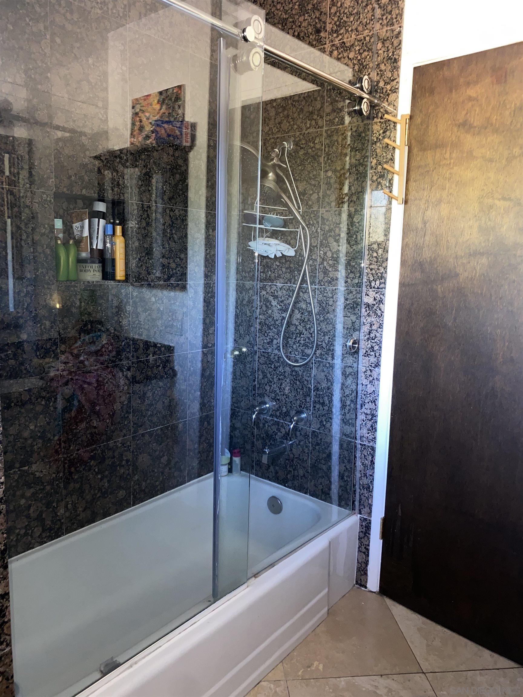 7325 Ouro Place La Mesa, CA 91941 - Photo 21 of 22 a bathroom with a bathtub and a shower