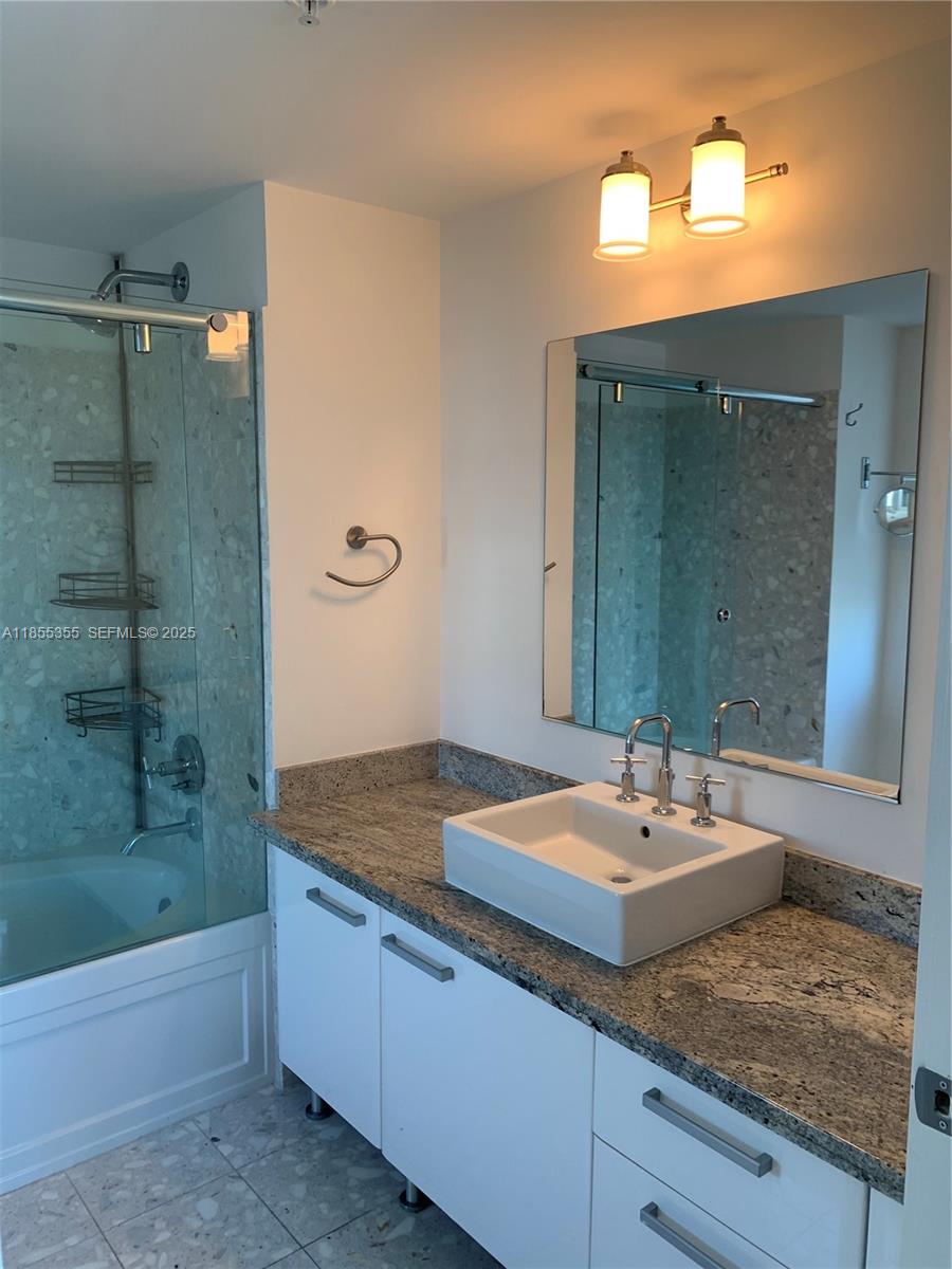 185 Southwest 7th Street, Unit 2202 Miami, FL 33130 - Photo 11 of 36 a bathroom with a sink and a mirror