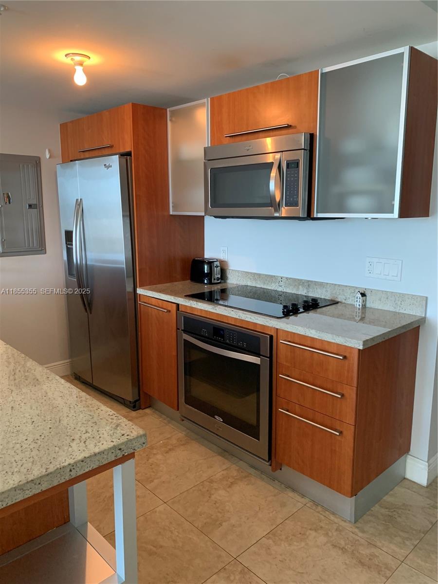185 Southwest 7th Street, Unit 2202 Miami, FL 33130 - Photo 3 of 36 a kitchen with stainless steel appliances granite countertop a stove microwave and refrigerator