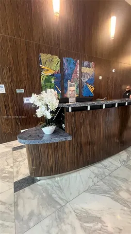 a view of a hall with the floor to ceiling windows and interior