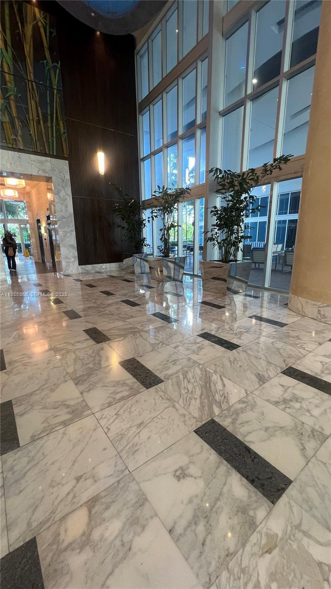 185 Southwest 7th Street, Unit 2202 Miami, FL 33130 - Photo 32 of 36 a view of a hall with the floor to ceiling windows and interior