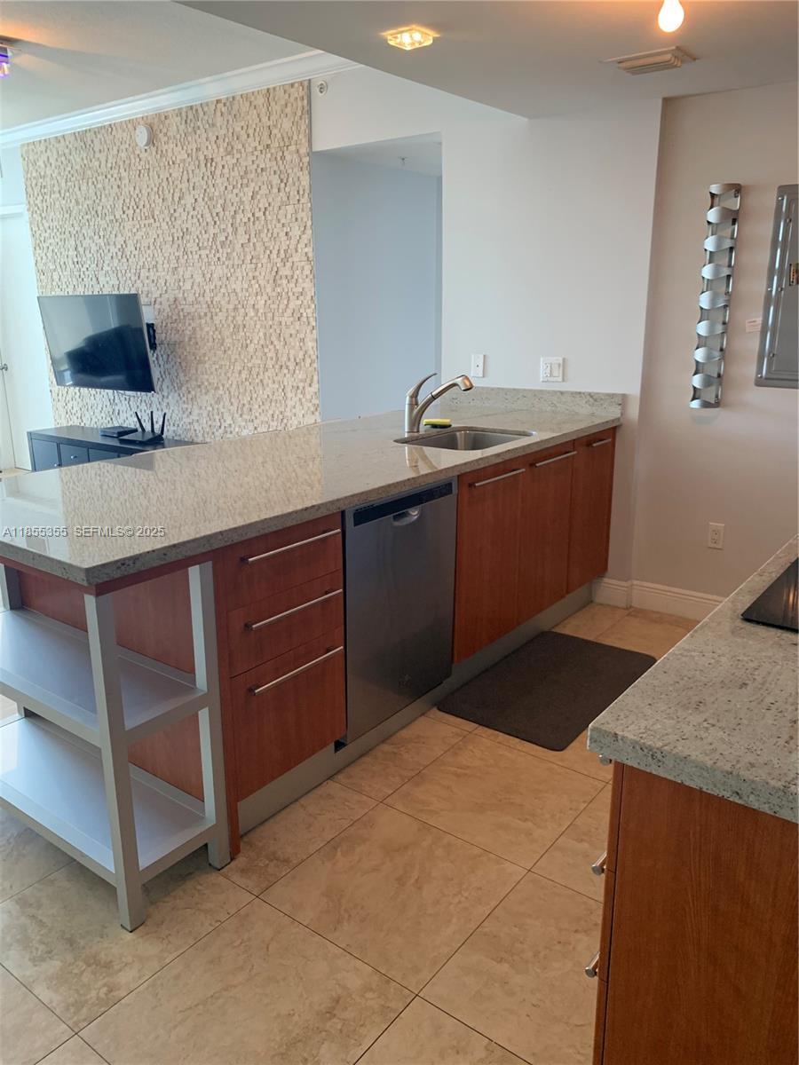 185 Southwest 7th Street, Unit 2202 Miami, FL 33130 - Photo 4 of 36 a kitchen with a sink and cabinets