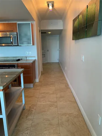 a view of hallway with livingroom and furniture