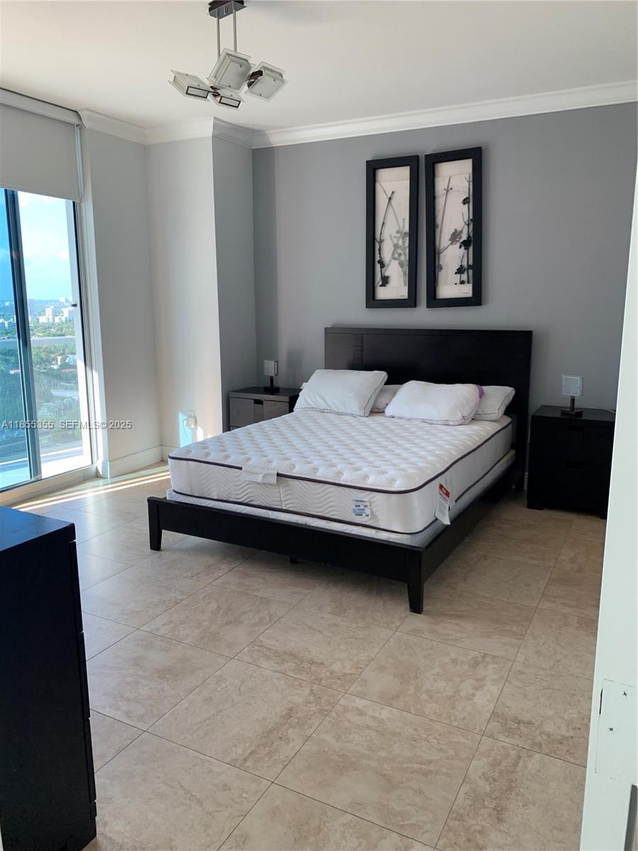 185 Southwest 7th Street, Unit 2202 Miami, FL 33130 - Photo 9 of 36 a bedroom with a bed and a window
