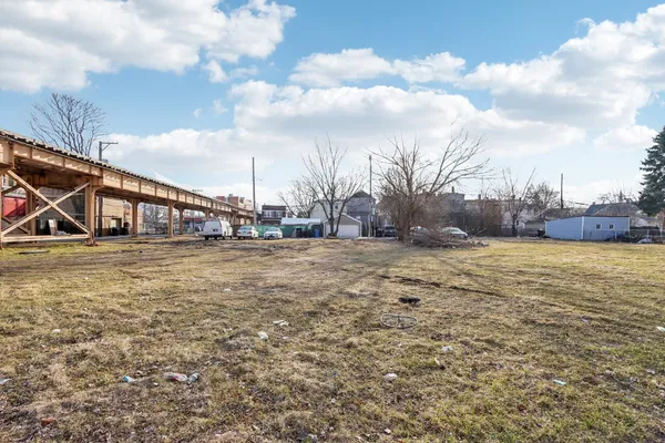 a view of open space with deck and residential houses