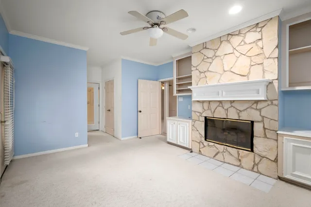 a view of a livingroom with a fireplace and a window