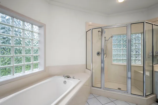 a bathroom with a bathtub and a shower
