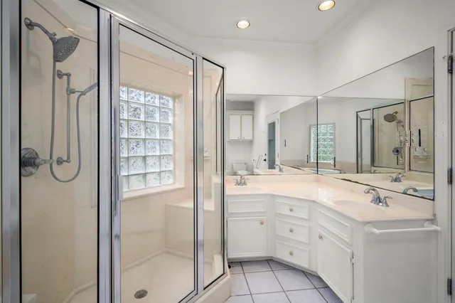 a bathroom with a shower sink and mirror