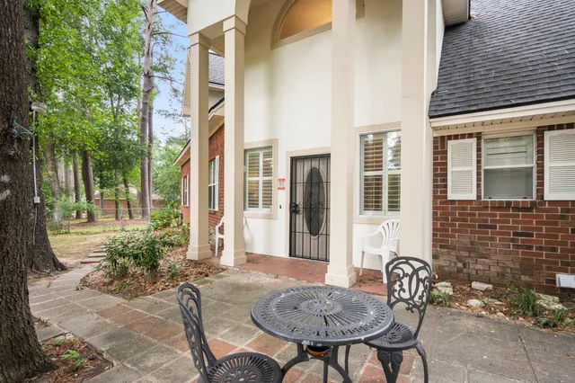 a view of a house with backyard and sitting area
