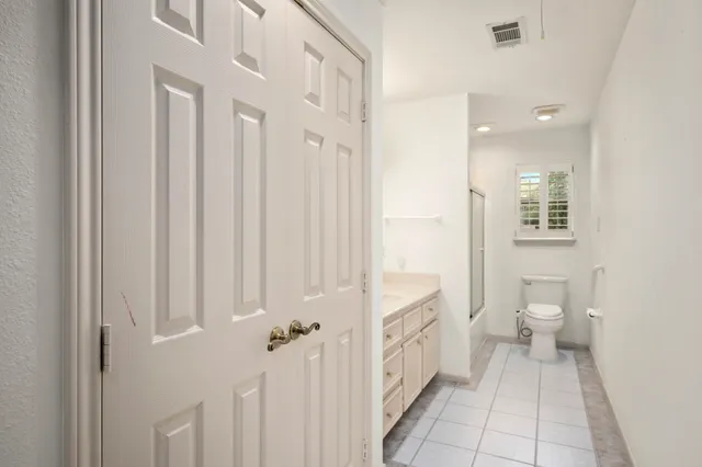 a bathroom with a toilet sink and a mirror