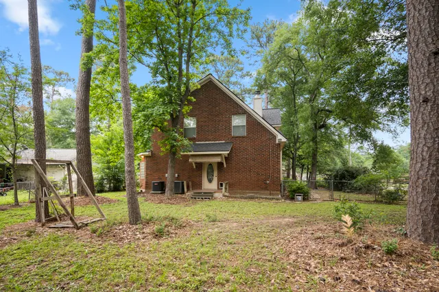 a house that has a tree in front of it